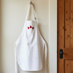Ladybug Embroidered Apron with three red and black ladybug embroidered on the bib.  Add personalization for a special gift.