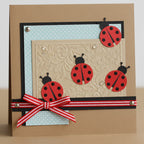 Four red ladybug embellishments with black heads, antennae, and spots are perfect for card making