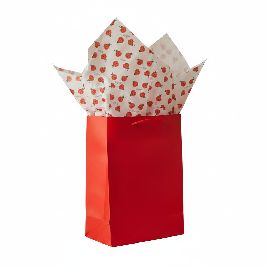 White tissue paper with a repeating pattern of red and black ladybugs  alternating with 'Ladybug' printed in blackscript.